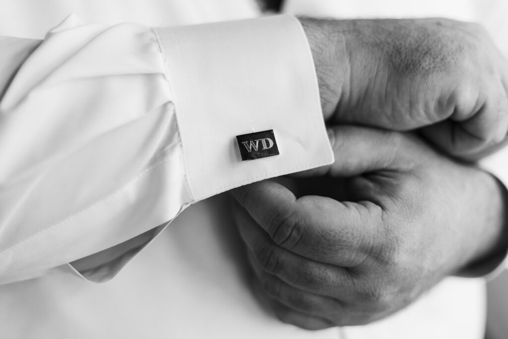 Customized cufflinks given as a wedding party gift to groomsmen.