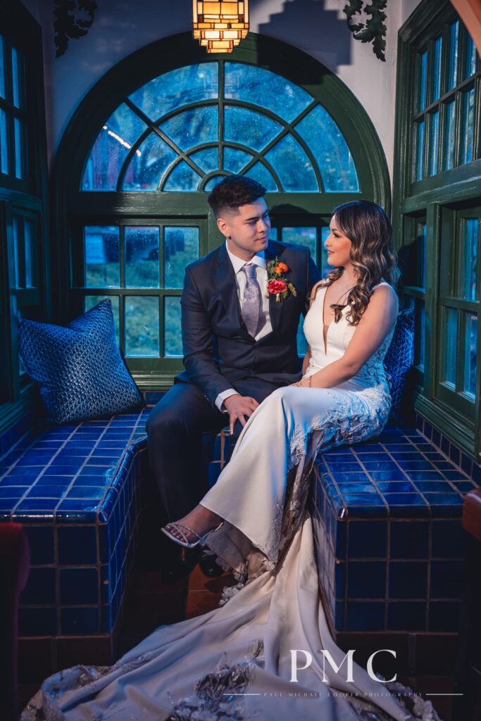 A bride and groom share a private moment in a rancho-style tiled room on their wedding day.