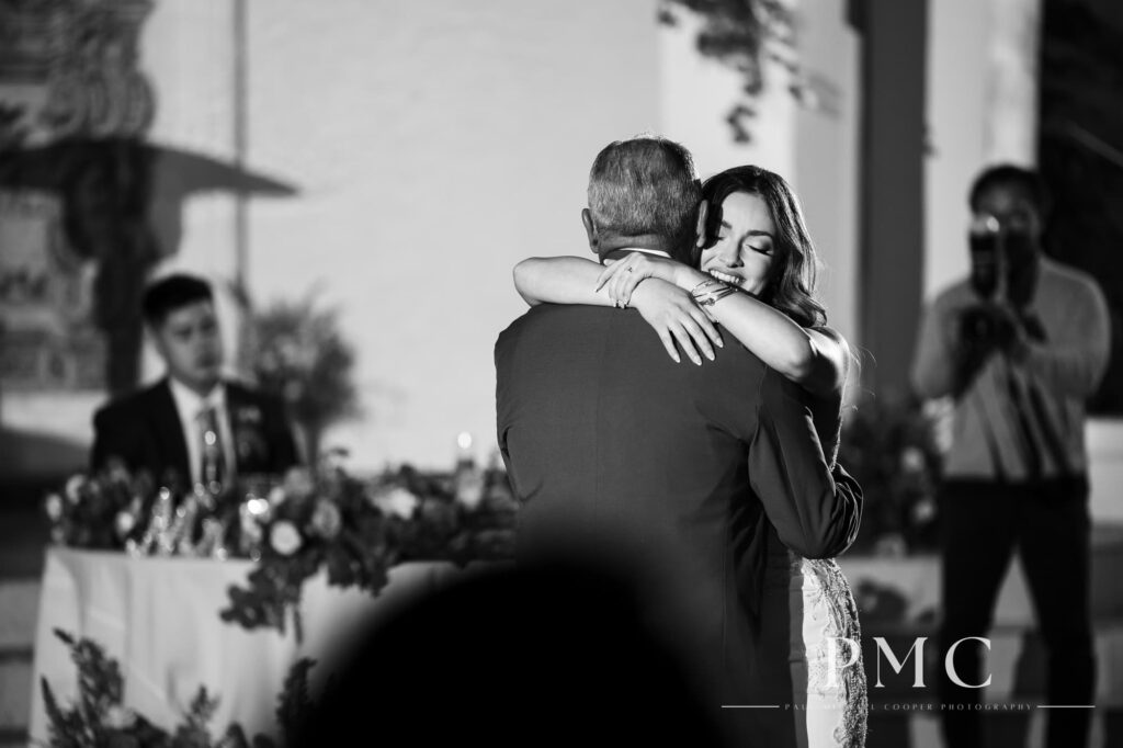 A bride shares a sweet father-daughter dance at her outdoor wedding reception.