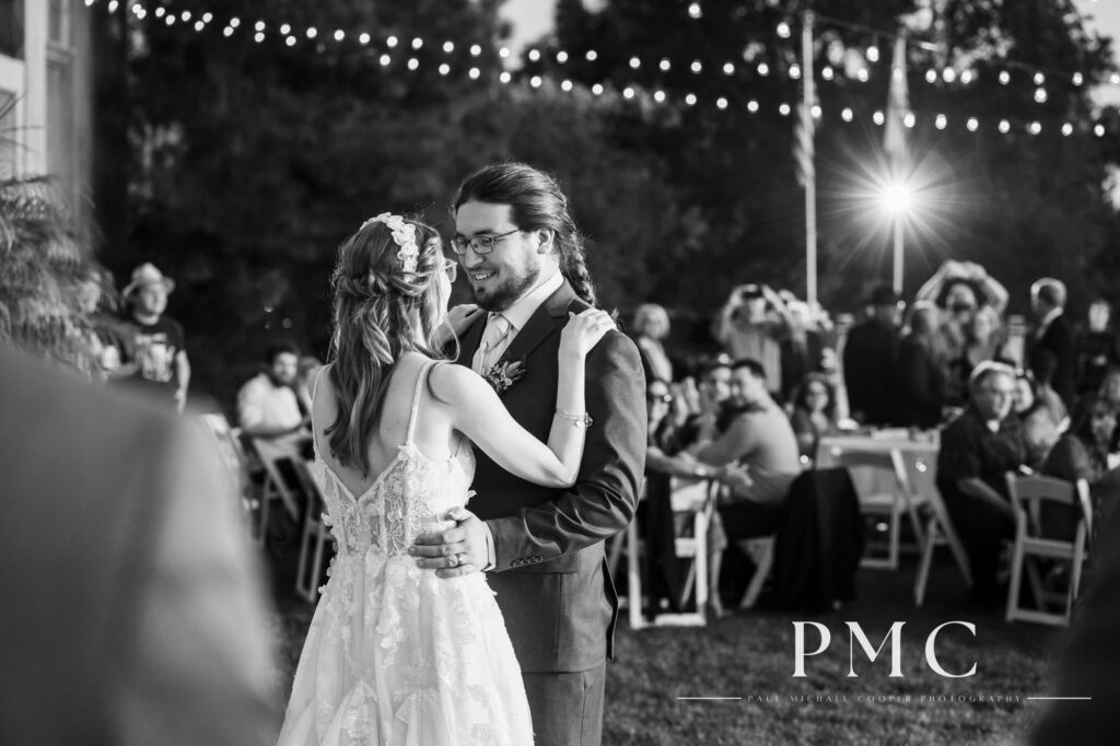 A bride and groom share their first dance in front of their guests at the reception of their fall wedding on a private estate in Escondido.