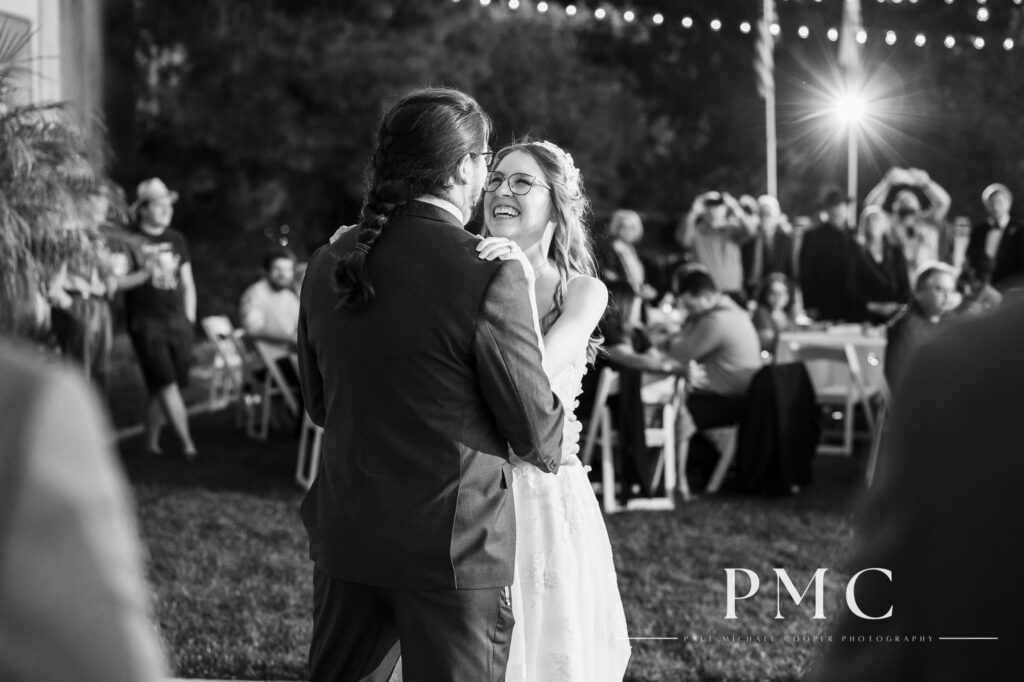 A bride and groom share their first dance in front of their guests at the reception of their fall wedding on a private estate in Escondido.