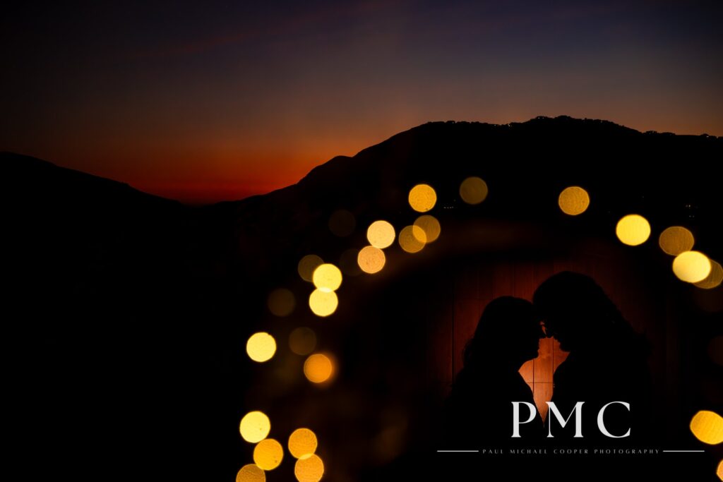 A silhouette of a bride and groom against the sunset of the Escondido valley.