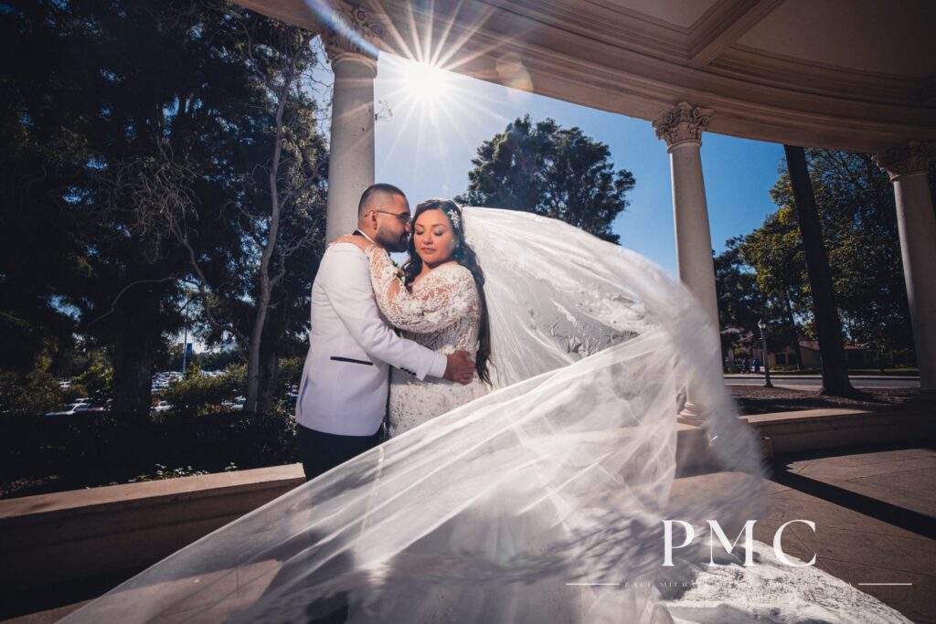 A bride and groom take romantic wedding photos at Balboa Park in San Diego.