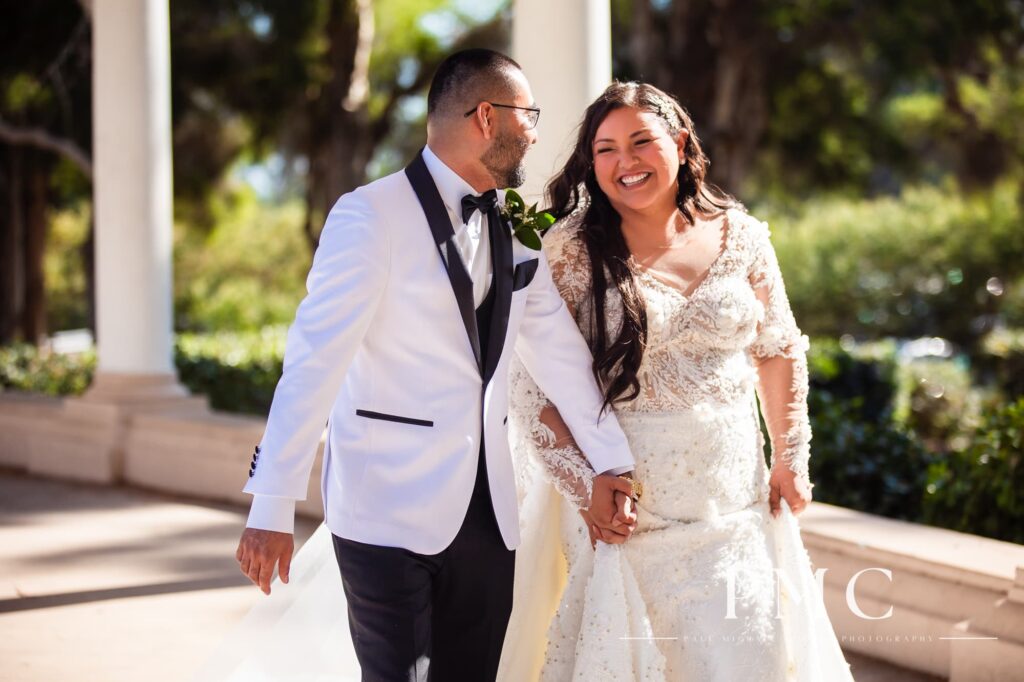 A bride and groom take romantic wedding photos at Balboa Park in San Diego.
