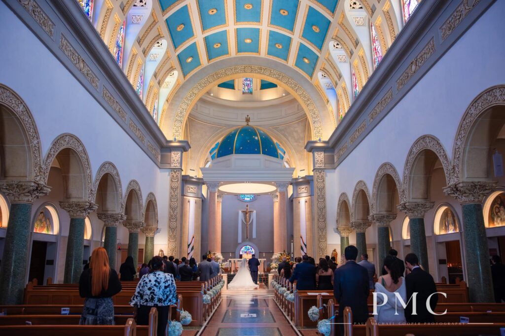 A wide photo from a wedding ceremony at the Immaculata Church at the University of San Diego.