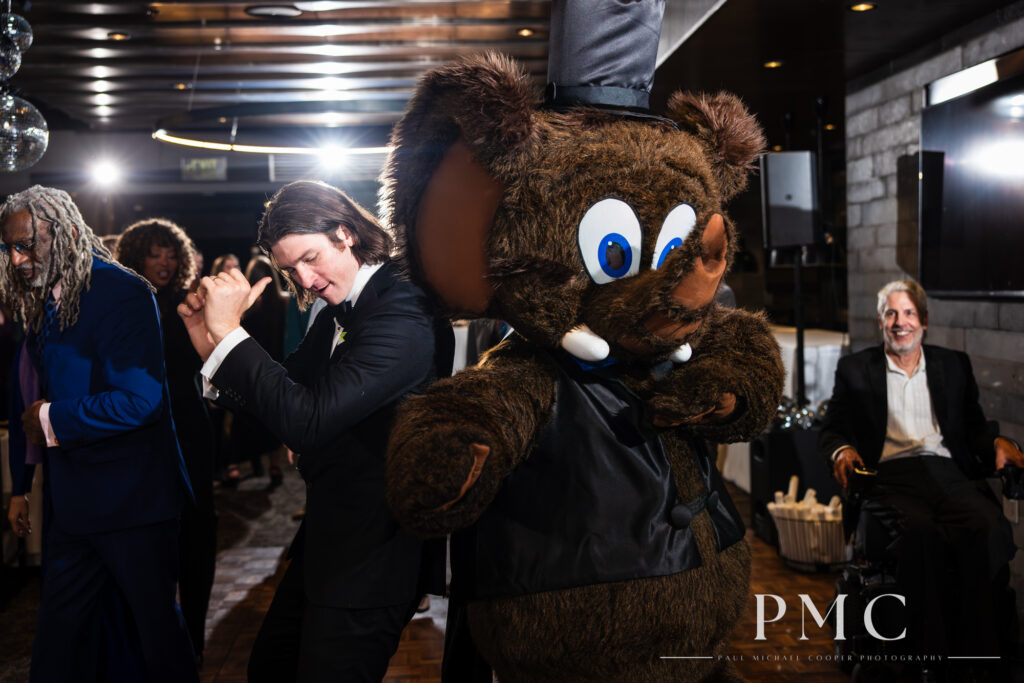 A groom dances with Wooly the Mammoth, the official mascot of Mammoth Mountain.