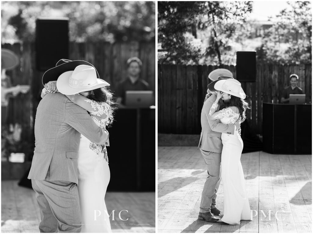 A bride and groom, both wearing boots and cowboy hats, share an emotional first dance during their reception on their country-style wedding day.