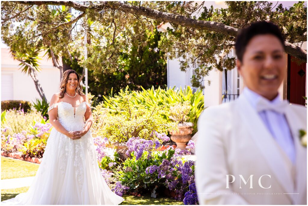 Two brides share a First Look moment on the front lawn of the historical Rancho Minerva Wedding Venue in Vista.