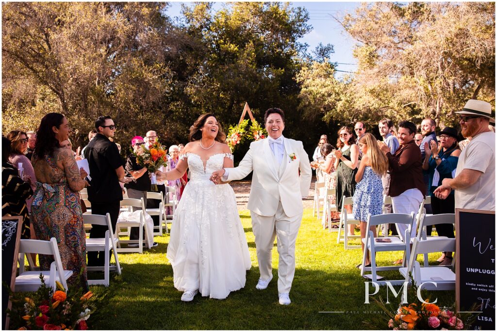 Two brides celebrate their terracotta-themed summer wedding at the historical Rancho Minerva Wedding Venue in Vista.