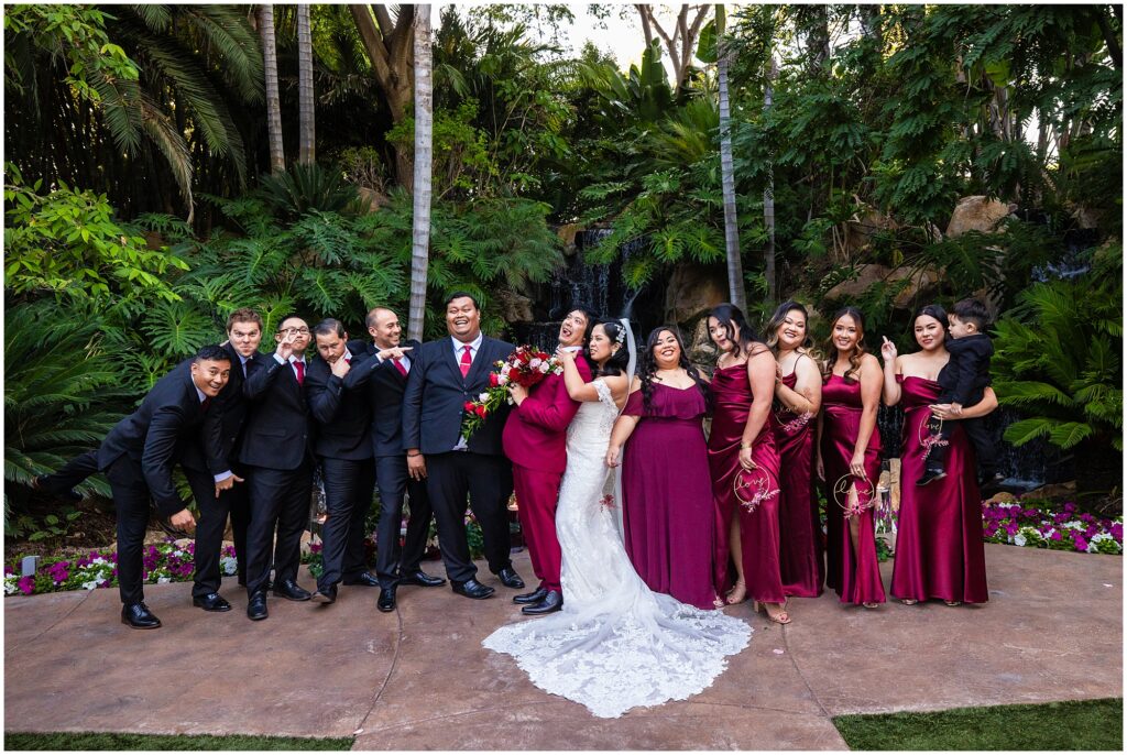 A wedding party strikes a fun pose at Grand Tradition Estate in Fallbrook, Southern California.