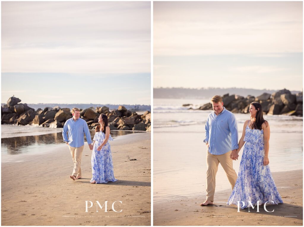 A couple walks while holding hands on Coronado Beach, San Diego.