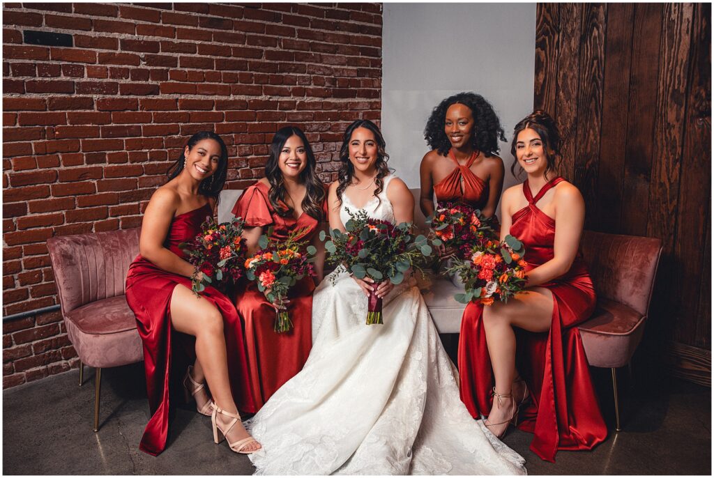 A winter bride and her bridesmaids. Photo by PMC Photography.